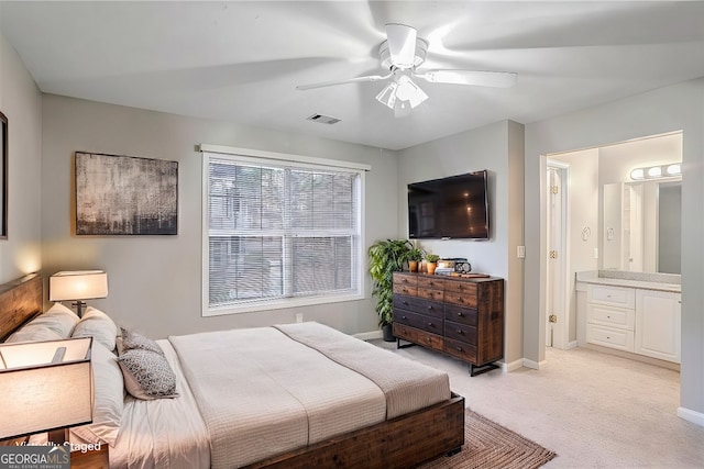 carpeted bedroom with ceiling fan and ensuite bathroom