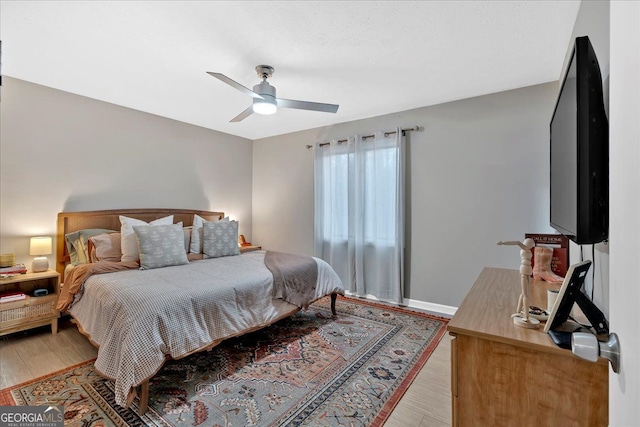 bedroom featuring ceiling fan and light wood-type flooring