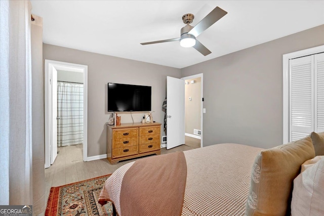 bedroom with connected bathroom, a closet, ceiling fan, and light wood-type flooring