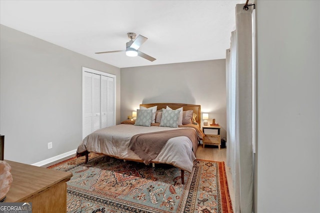 bedroom featuring a closet, ceiling fan, and light wood-type flooring