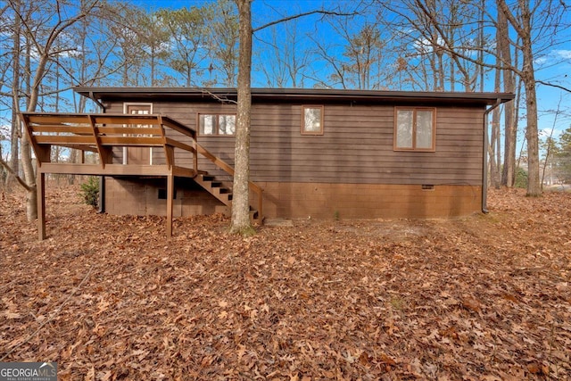 view of side of home featuring a wooden deck