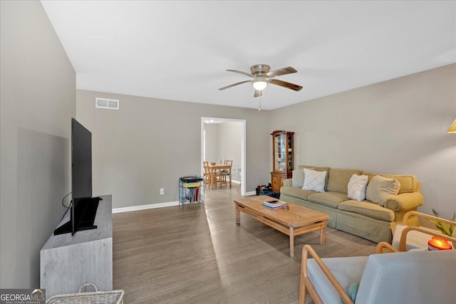 living room with hardwood / wood-style flooring and ceiling fan