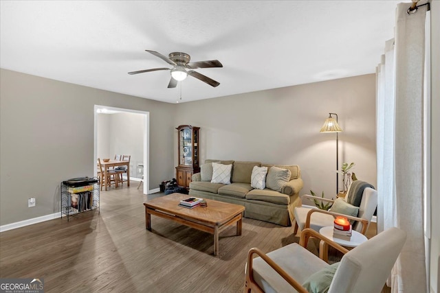 living room featuring hardwood / wood-style flooring and ceiling fan