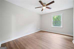 unfurnished room featuring ceiling fan and hardwood / wood-style floors