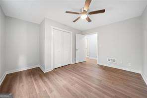 unfurnished bedroom featuring a closet, ceiling fan, and dark hardwood / wood-style floors