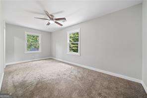 unfurnished room featuring carpet and ceiling fan