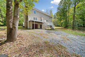 back of property featuring a wooden deck