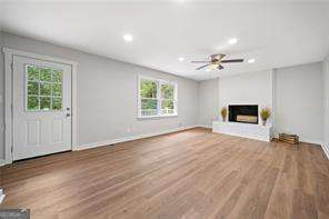 unfurnished living room with hardwood / wood-style floors and ceiling fan