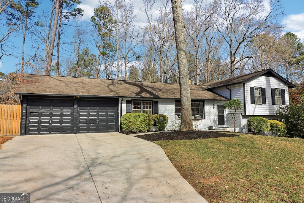 view of front of property with a garage and a front yard