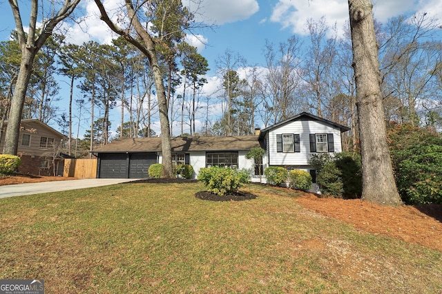 split level home with a garage and a front lawn