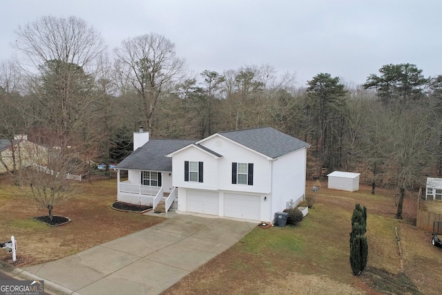 view of front of property featuring a garage, a front lawn, a storage unit, and a porch