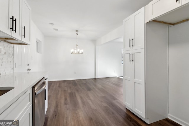 kitchen featuring dishwasher, white cabinets, dark hardwood / wood-style flooring, hanging light fixtures, and an inviting chandelier