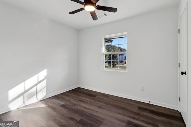 empty room with dark wood-type flooring and ceiling fan