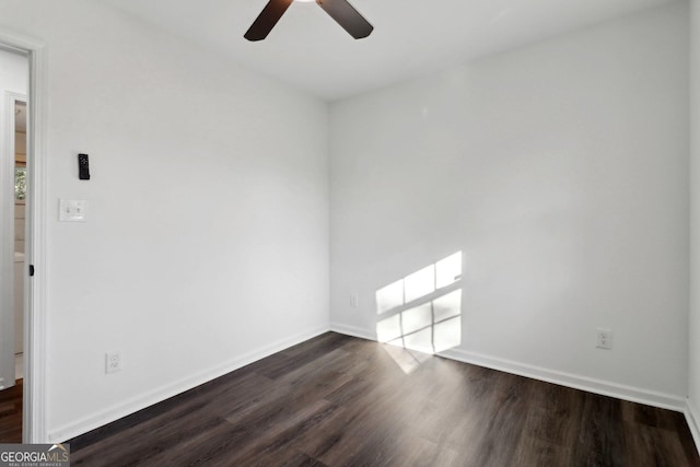 unfurnished room with ceiling fan and dark hardwood / wood-style flooring