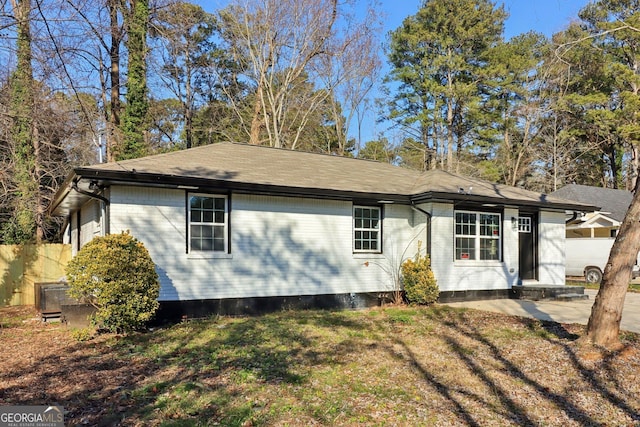 rear view of property with a yard