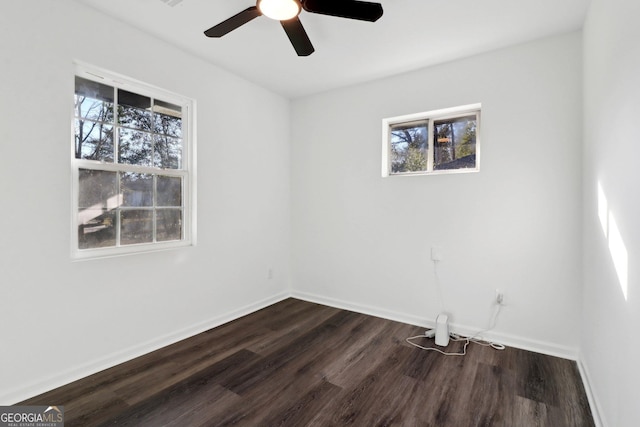 unfurnished room featuring ceiling fan, plenty of natural light, and dark hardwood / wood-style flooring