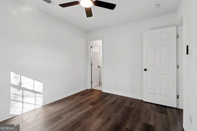 spare room featuring ceiling fan and dark hardwood / wood-style flooring