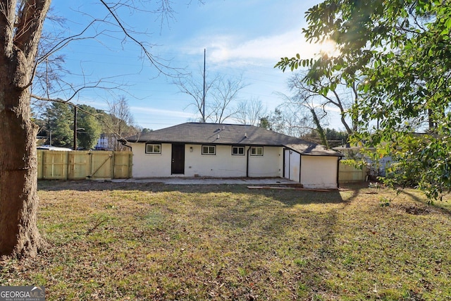 rear view of house featuring a lawn