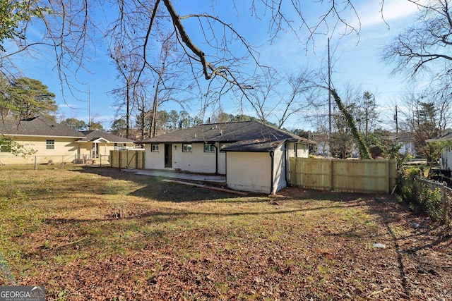 rear view of property with a yard