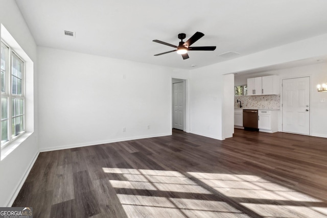 unfurnished living room featuring dark hardwood / wood-style floors and ceiling fan