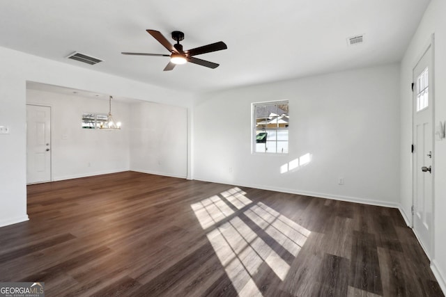 interior space featuring dark hardwood / wood-style floors and ceiling fan with notable chandelier