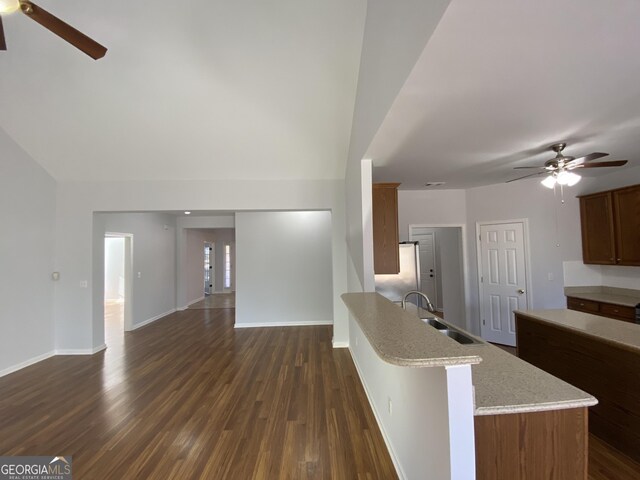 kitchen featuring sink, a center island, stainless steel dishwasher, dark hardwood / wood-style floors, and decorative backsplash