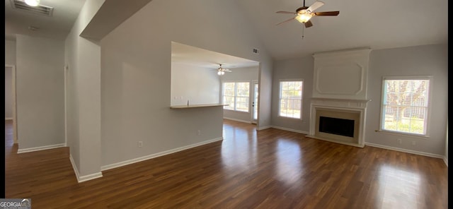 unfurnished living room with dark hardwood / wood-style floors, ceiling fan, a fireplace, and high vaulted ceiling