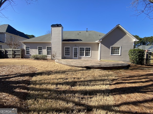 rear view of property with a lawn