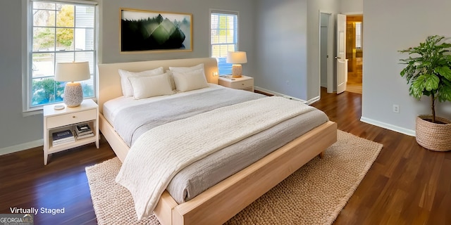 bedroom with dark hardwood / wood-style floors