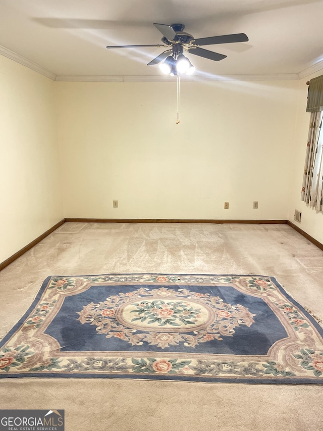 spare room featuring crown molding and light colored carpet