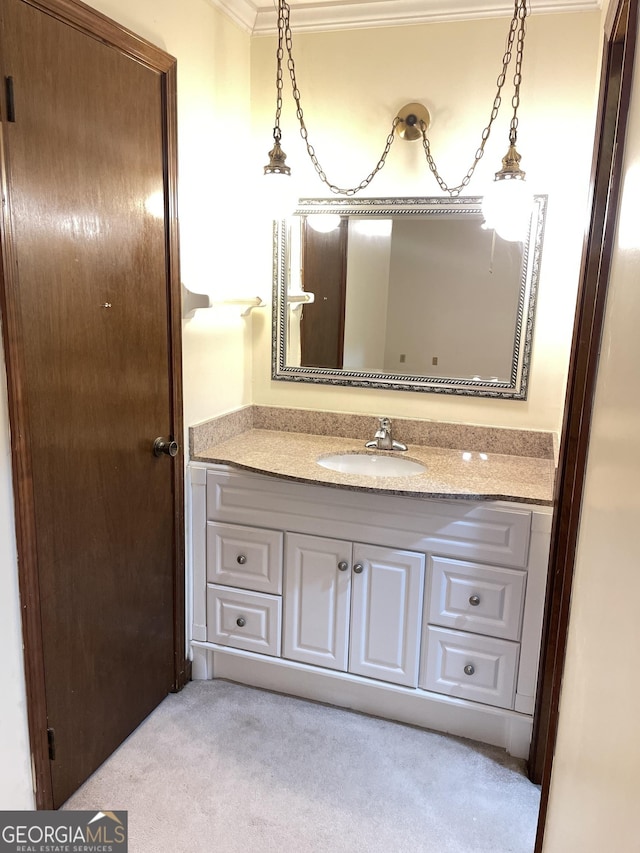 bathroom with crown molding and vanity