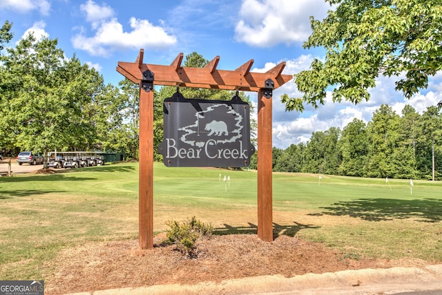 community / neighborhood sign with a yard