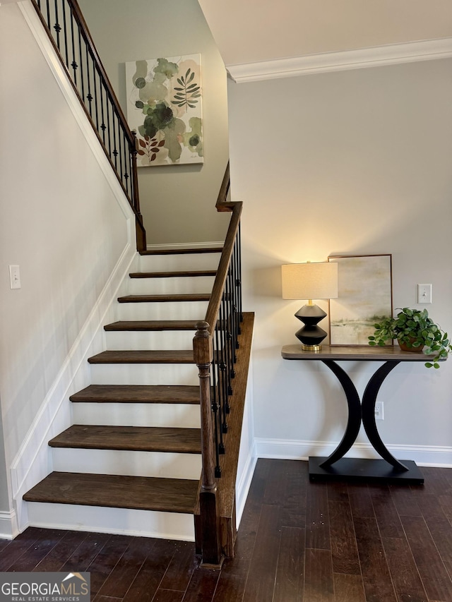 stairway with wood-type flooring and baseboards