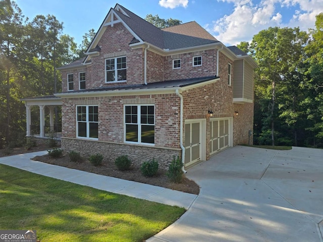 view of home's exterior with a garage, a shingled roof, concrete driveway, a yard, and brick siding