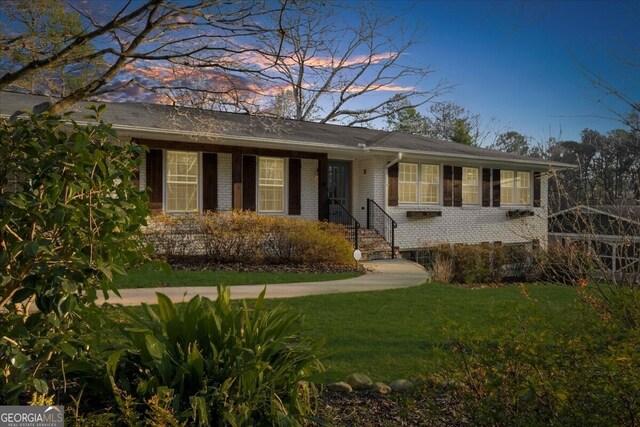 view of front of property with a garage and a front lawn