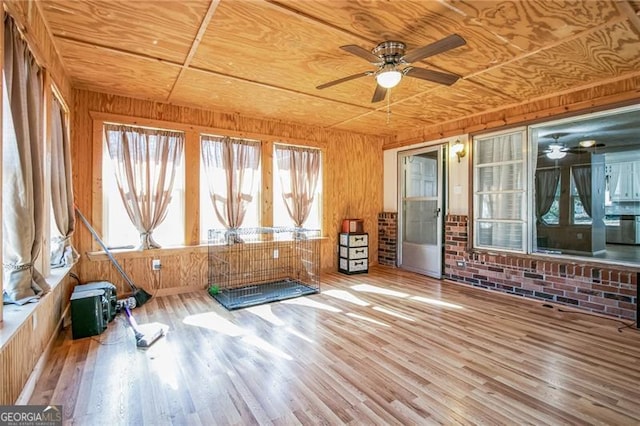 unfurnished sunroom featuring ceiling fan and wood ceiling