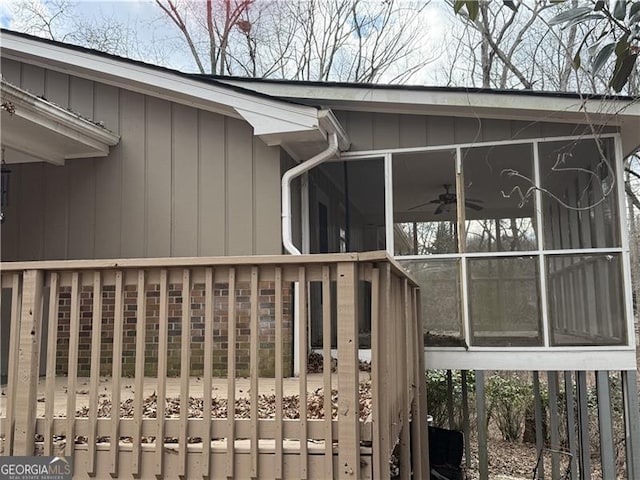 view of home's exterior featuring a sunroom and ceiling fan