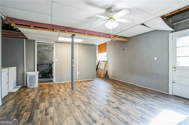 basement featuring hardwood / wood-style flooring, a paneled ceiling, washing machine and dryer, and ceiling fan