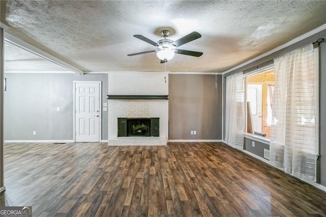 unfurnished living room with a fireplace, dark wood-type flooring, a textured ceiling, and ceiling fan