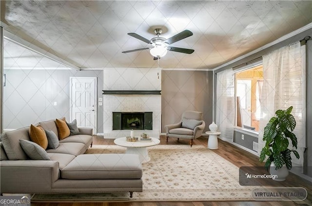 living room with crown molding, a fireplace, and hardwood / wood-style flooring