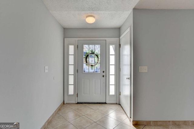 tiled foyer with a textured ceiling