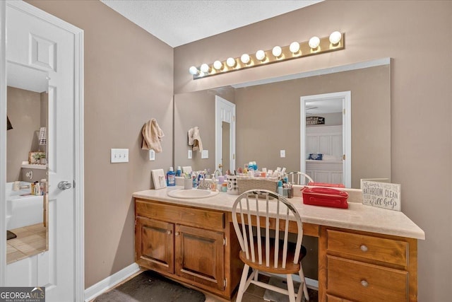 bathroom with vanity and a textured ceiling