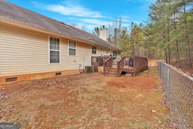 rear view of property featuring cooling unit and a deck