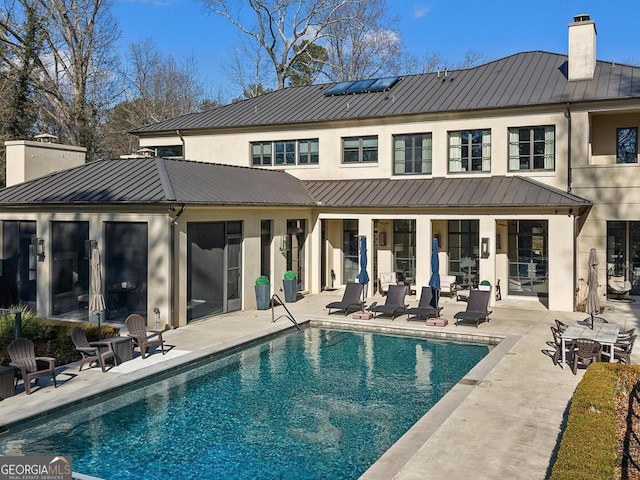 1500 W Wesley Rd NW, Atlanta, GA 30327 - back of house featuring a patio, metal roof, a chimney, and a standing seam roof