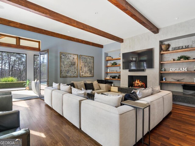 1500 W Wesley Rd NW, Atlanta, GA 30327 - living area featuring dark wood-type flooring, built in features, a fireplace, and beamed ceiling