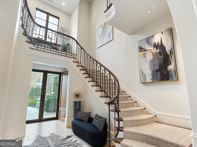 1500 W Wesley Rd NW, Atlanta, GA 30327 - stairs featuring baseboards, plenty of natural light, and tile patterned flooring