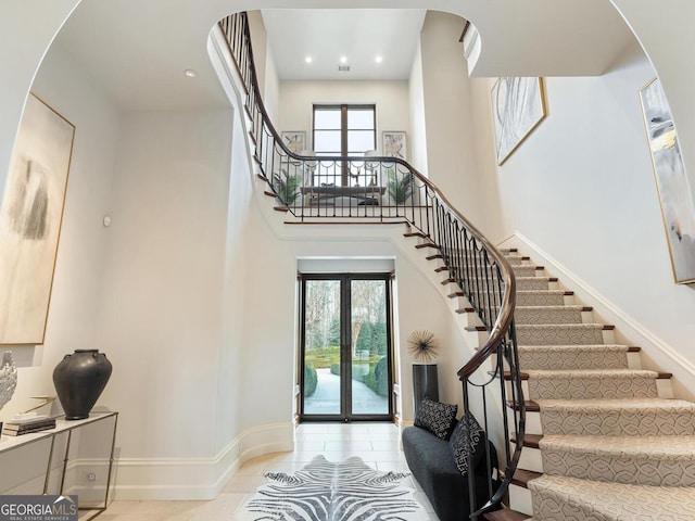 1500 W Wesley Rd NW, Atlanta, GA 30327 - foyer with french doors, arched walkways, stairs, and baseboards