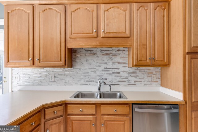 kitchen featuring tasteful backsplash, sink, and dishwasher