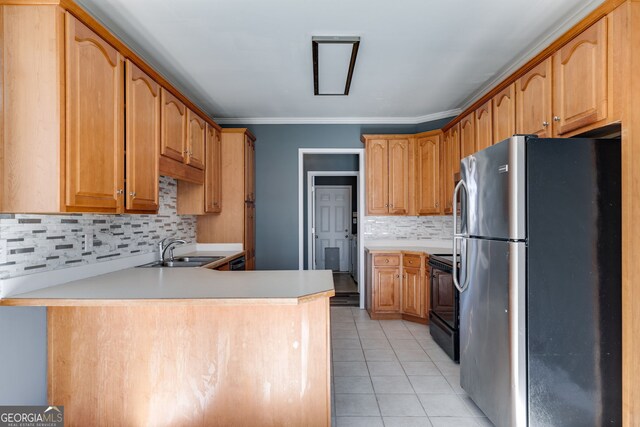 kitchen with black electric range oven, sink, stainless steel fridge, and kitchen peninsula