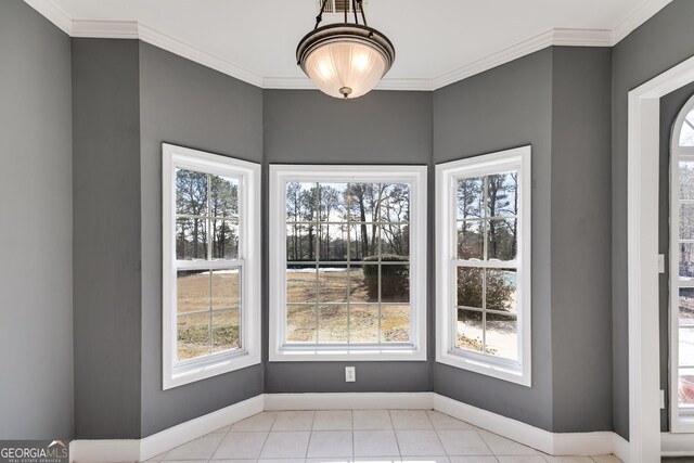 unfurnished dining area with crown molding and light tile patterned floors